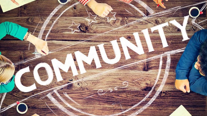 "Community" written in chalk on wooden surface