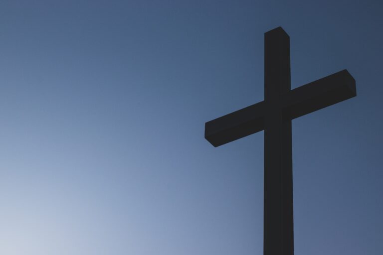 Wooden cross in front of blue sky