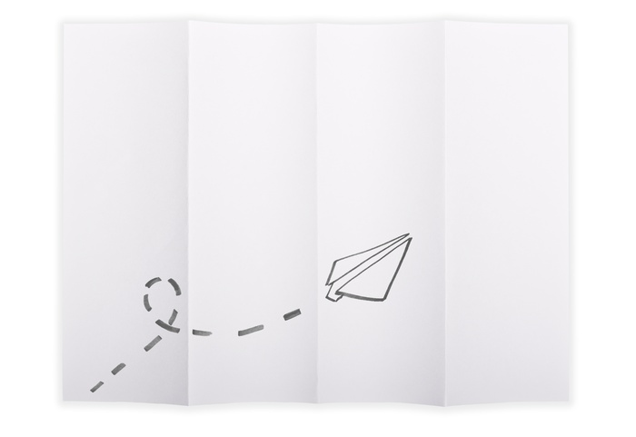 White paper sheet folded in 4 quarters isolated over a white background with a paper airplane sketched on it