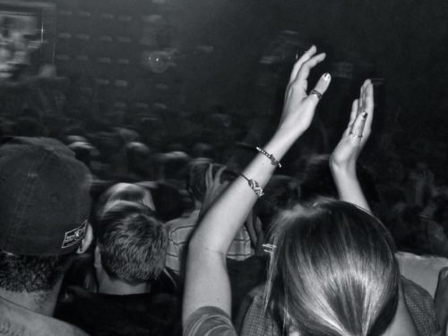 Person clapping hands in a crowd of people