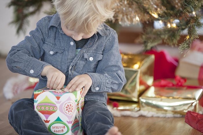 Young child opening a gift on Christmas